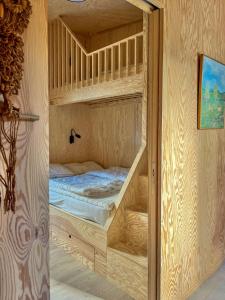 a bedroom with bunk beds in a wooden room at Architect-Designed House Near Sea On Resö in Resö