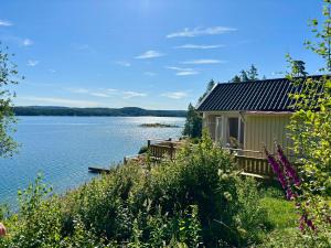 a cabin on the shore of a lake at Romantic Summer House On Orust in Stillingsön