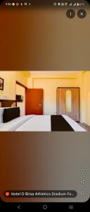 Ένα ή περισσότερα κρεβάτια σε δωμάτιο στο Ambika Residency