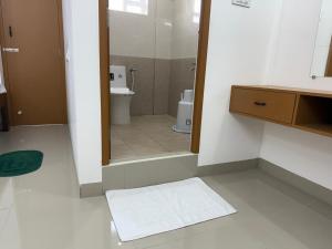 a bathroom with a shower and a sink and a toilet at Pondicherry Comfort Rooms in Puducherry +27 photos