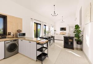 a kitchen with a table and a stove in a room at Zeus Holiday Home in Pissouri