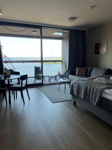 a living room with a bed and a table and a couch at Marinan Portin Svingi A23 lemmikit sallittu in Kalajoki