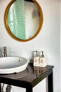 a bathroom with a sink and a mirror at Beyoung Hotel Dalat in Da Thanh