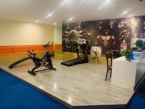 a gym with exercise bikes and a treadmill at Shell Shanghai Songjiang District Xinqiao Town Xinqiao Hotel in Chunshen