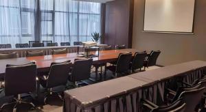 a conference room with a long table and chairs at Ease Hotel Xi'an High-tech Zone 4th Zhangba Road Metro Station in Xi'an +12 photos