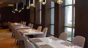 a row of tables and chairs in a room with windows at Ease Hotel Xi'an High-tech Zone 4th Zhangba Road Metro Station in Xi'an