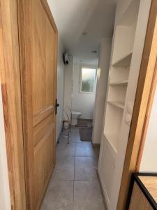 a hallway with a door and a toilet in a room at Gîte cosy avec jardin in Nyons