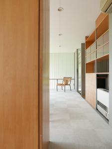 a hallway of a house with a bench in the distance at OGUNI S HOUSE 2F Designed by Toyo Ito in Oguni