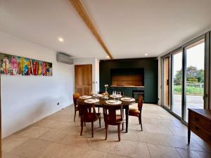 a kitchen and dining room with a table and chairs at Ferme Ihartzetako in Ascain