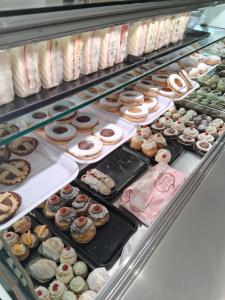 a display case filled with lots of different types of donuts at Casa Ginevra in Reggio Calabria