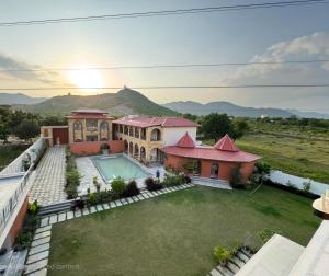 an aerial view of a house with a swimming pool at Nazaara Hills Retreat in Thūr