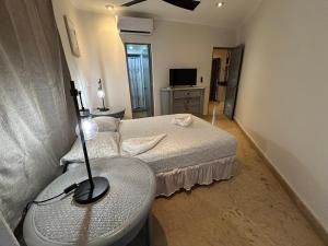 a small bedroom with a bed and a sink at Blue angel 24 in Playa del Carmen