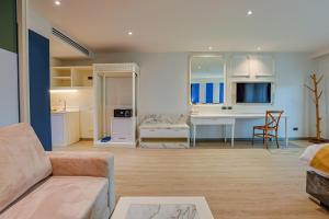 a living room with a couch and a desk at Aqua Resort Aonang Krabi in Ao Nang Beach