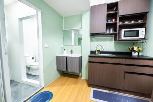 a small bathroom with a sink and a toilet at GL Sport Club Serviced Residence & Hotel in Bangkok +59 photos