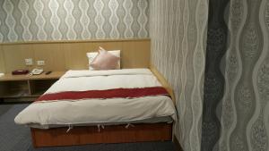 Postel nebo postele na pokoji v ubytování Mei Hua Hotel