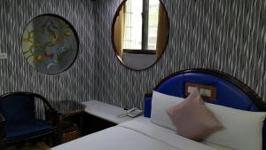 Postel nebo postele na pokoji v ubytování Mei Hua Hotel