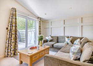 a living room with a couch and a table at Henfields Country Retreat in Otterhampton +71 photos