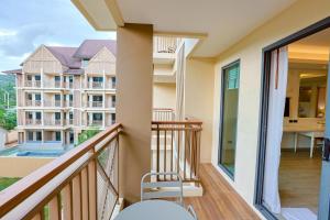 a balcony with a view of a building at Aqua Resort Aonang Krabi in Ao Nang Beach