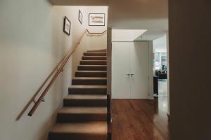 a staircase in a house with a stair case at Liardett Penthouse - Inner city accommodation in New Plymouth
