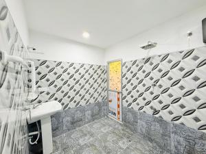 a bathroom with a shower and a sink and a toilet at Sigiri Thaniya Villa in Sigiriya
