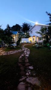 a stone path in front of a house at DM Farms Morni Hills Panchkula in Morni