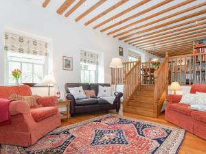 a living room with a couch and chairs and a staircase at Ty Menyn in Mathry