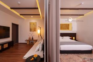 a hotel room with two beds and a tv at Xi'an Da Tang Yin Courtyard Hotel in Xi'an