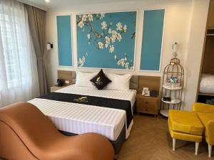 a bedroom with a bed and a painting on the wall at One Villa Hotel 6 in Long Biên