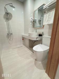 a bathroom with a toilet and a sink and a mirror at One Villa Hotel 6 in Long Biên +6 photos