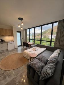 a living room with a couch and a table at Mirşah Suit in Bezkesen +37 photos
