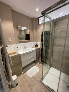 a bathroom with a glass shower and a sink at L'Escale Sètoise in Sète +29 photos