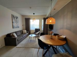 a living room with a table and a couch at Levi Nordic Light in Levi