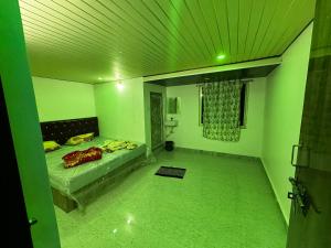 a green room with a bed and a green ceiling at Sunrise Resort in Araku