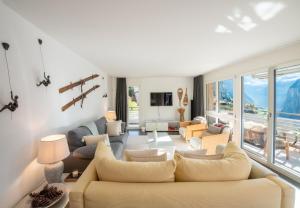 a living room with a couch and a table at Chalet Silence in Wengen