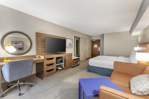 a hotel room with a bed and a tv at Hampton Inn New Bern in New Bern