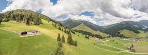 a green field with a house on top of it at Grubi´s Chalet Alm in Gerlos