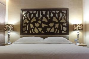 Ένα ή περισσότερα κρεβάτια σε δωμάτιο στο Wyndham Surabaya