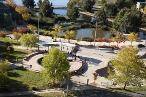 a park with a fountain and trees and water at Sleek 2-Bed Apartment with Rooftop Garden Access in Belconnen