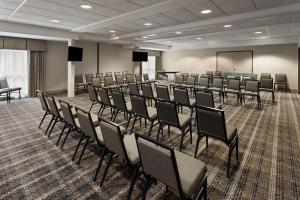 a conference room with chairs and a board in it at Days Inn by Wyndham Penn State in State College