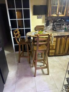 a kitchen with a table and chairs in a kitchen at Jamaica R Home in Kingston
