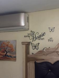 a bedroom with a bed with butterflies on the wall at Jamaica R Home in Kingston