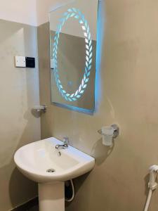a bathroom with a sink and a mirror on the wall at Liyara Lodge Sigiriya in Sigiriya
