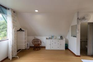 a room with a white cabinet and a window at Kanso Hill Lowii Cottage in Kampong Kundassan