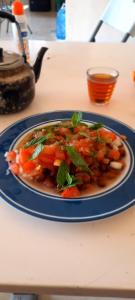 a plate of food with carrots and greens on a table at استراحة الباشا albash farm stay in Al Karāmah
