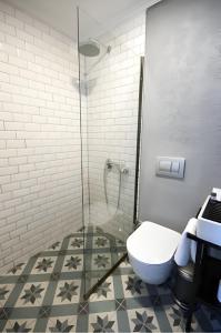 a bathroom with a toilet and a glass shower at Smart City Suites Hotel Bodrum in Bodrum City +23 photos