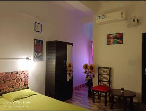 a bedroom with a bed and a table with flowers at Hotel Baruah Tower in Tezpur +2 photos