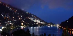 a view of a river at night with a city at Belvedere Palace Nainital in Nainital