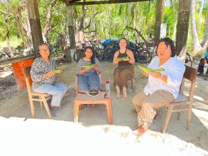a group of women sitting in chairs under a tree at Delft Aquatic Tourist Hotel in Delft Centre