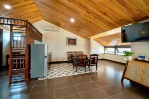 a living room with a kitchen and a dining room at Virgo Villa Quê Hội An in Hoi An
