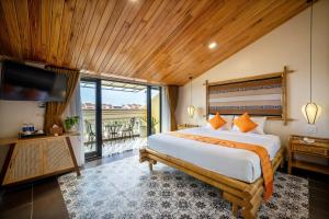 a bedroom with a large bed and a television at Virgo Villa Quê Hội An in Hoi An +79 photos